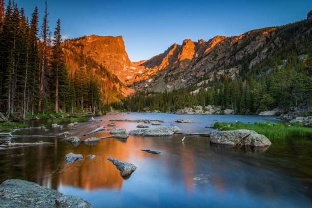 Dream Lake at Sunrise Alpenglow kisses Hallet Peak in Rocky Mountain National Park estes park stock pictures, royalty-free photos & images