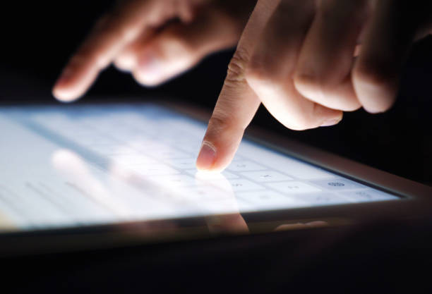 istock Closeup fingers typing texting a message on tablet 996409536