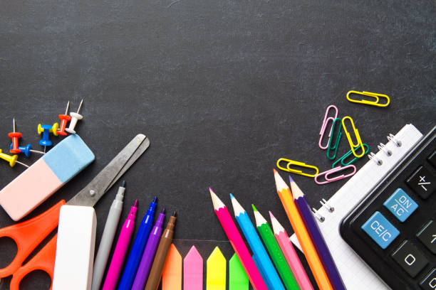 istock School supplies on blackboard background . The concept of education, study, learning, elearning. Back to school 996412732