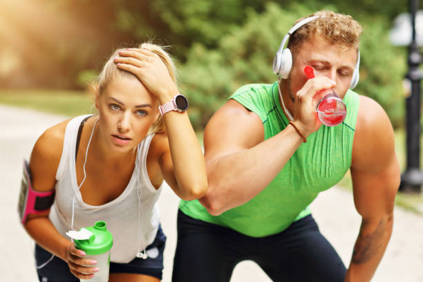 istock Young couple jogging in park 996415638