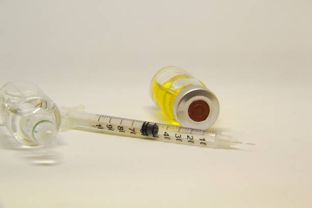 istock medical ampoules with syringe isolated on white background 996417232