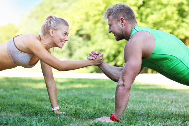 istock Young couple jogging in park 996421528