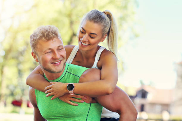 istock Young couple jogging in park 996422766