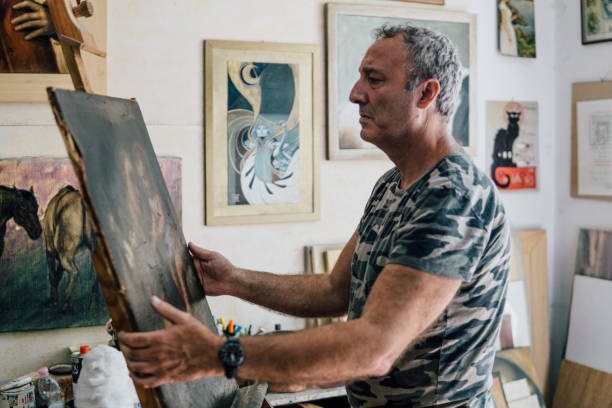 istock Artist restoring an old painting 996434512