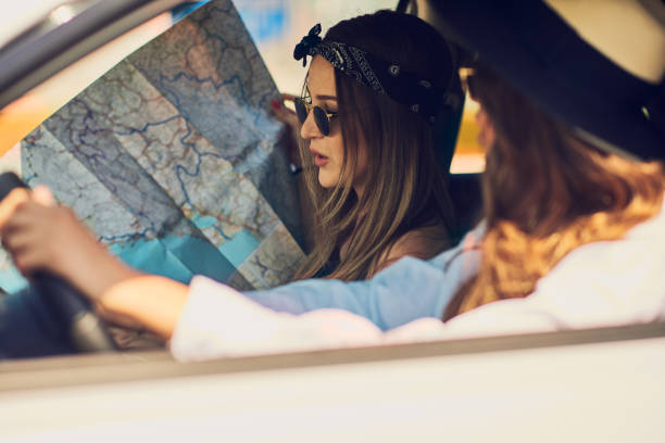 istock Two girls having fun driving. 996434948