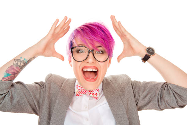 Stylish millennial woman with short magenta pink dyed hair holding hands around head in great excitement and happy disbelief isolated on white background