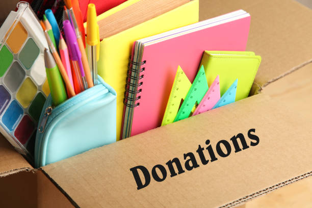 istock Different school supplies in a cardboard box 996439014