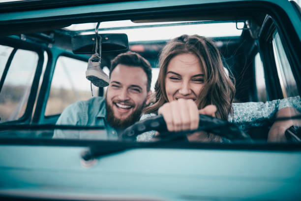 Couple Riding In Vintage Car And Having Fun
