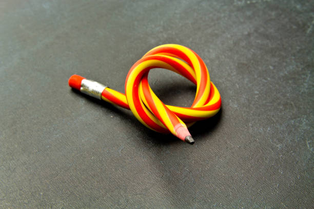 istock Flexible pencil on a  background. Bent pencils  two-color 996442448