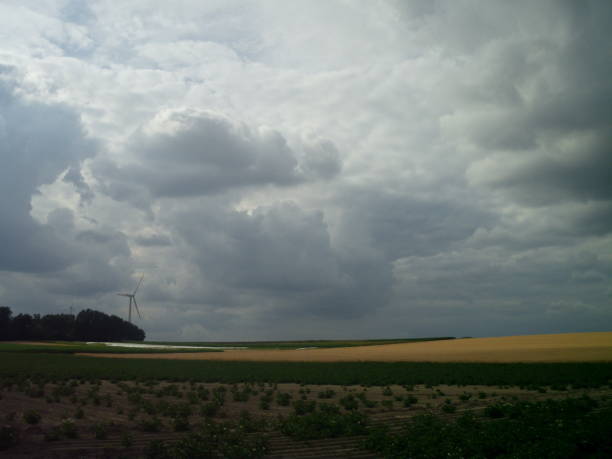 istock Wind turbine in European summer fields with clouds before rain 996448528