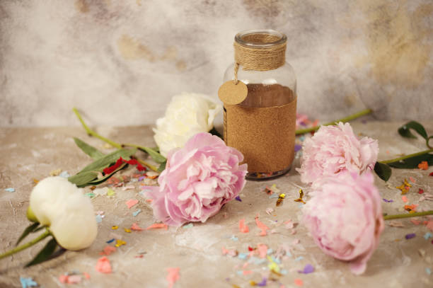 istock Fresh pink peonies flowers on aged wooden background. Selective focus. Toned image. 996455612