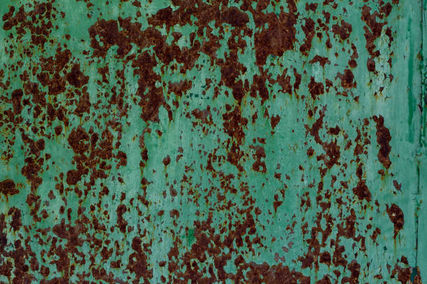 istock Texture of an old rusty metal wall with peeling green paint 996457238