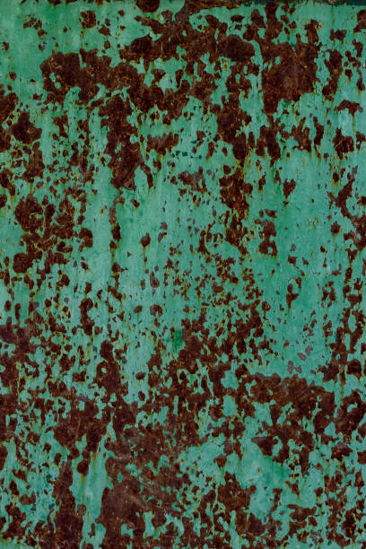 istock Texture of an old rusty metal wall with peeling green paint 996457338