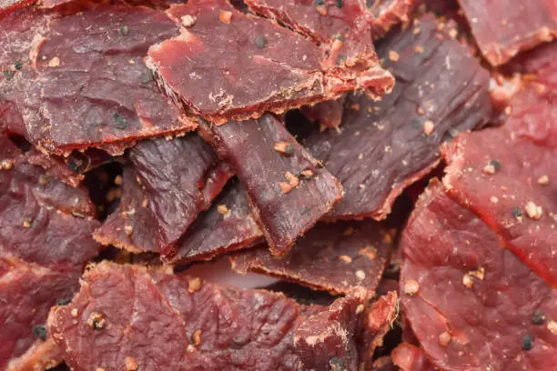 Peppered Beef Jerky close up full frame background