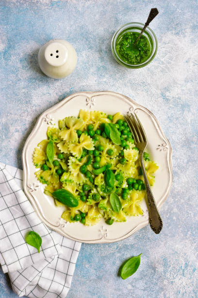 istock Farfalle pasta with pesto sauce and green pea 996469262
