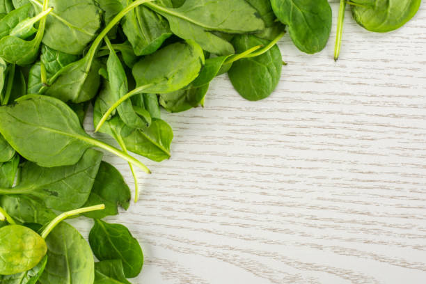 istock Fresh raw green spinach on grey wood 996471574