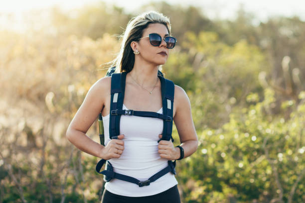 istock Happy young woman hiking with backpack 996475848