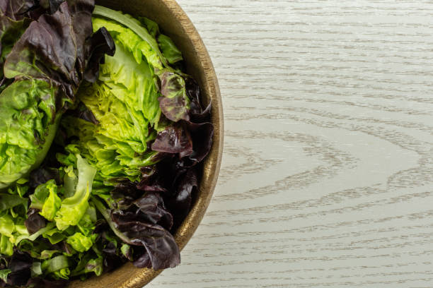 istock Fresh raw lettuce red little gem on grey wood 996475920