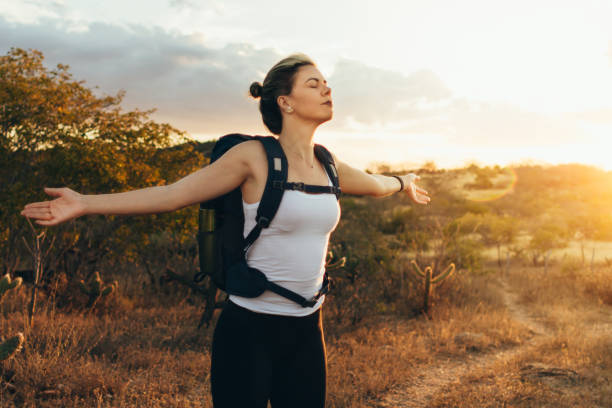 istock Happy young woman hiking with backpack 996478612