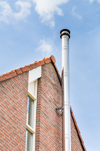 pipe on roof of wooden beam cottage villa house on sky background