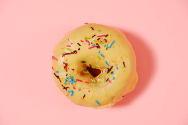 istock Delicious donut on pink background 996481852