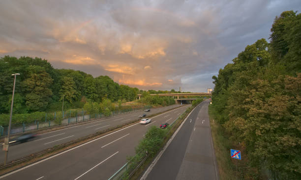 istock Traffic on germany highway in the evening under a rainbow 996484248
