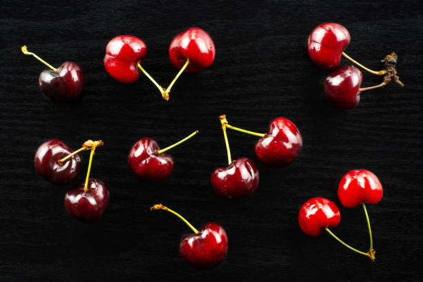 istock Fresh raw sweet red cherry on black wood 996486888