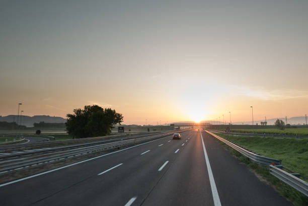 istock Highway travel background, motorway towards sun 996490114