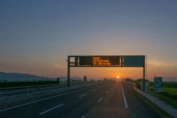istock Keep attention to driving written on highway road sign 996490224
