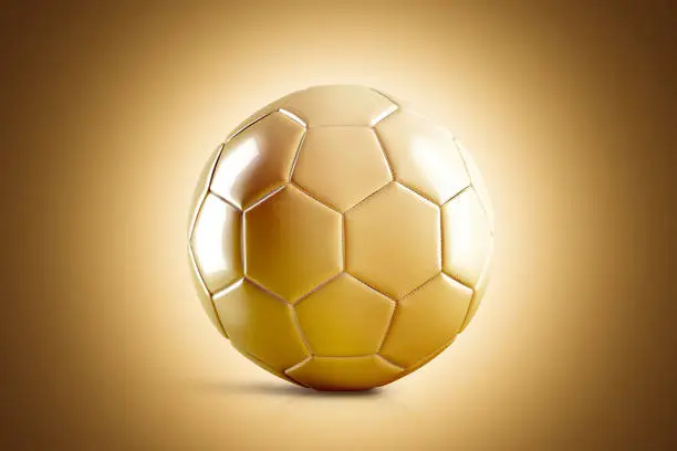 Blank golden soccer ball mock up, front view, 3d rendering. Glossy gold football sphere mockup on brown surface. Sport bal for playing on the clean field template