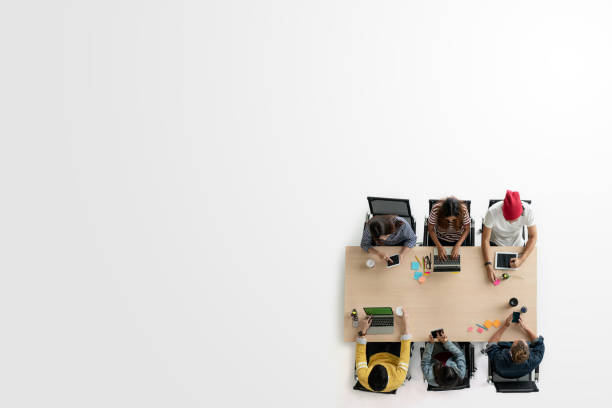 istock Top view of diverse people of creative team group using smartphone, tablet and computer laptop. Overhead of asian young creative start up meeting. Have copy space for fill text 996492530