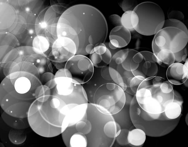 istock white bokeh on black background, circles, glitter, black and white background 996493064