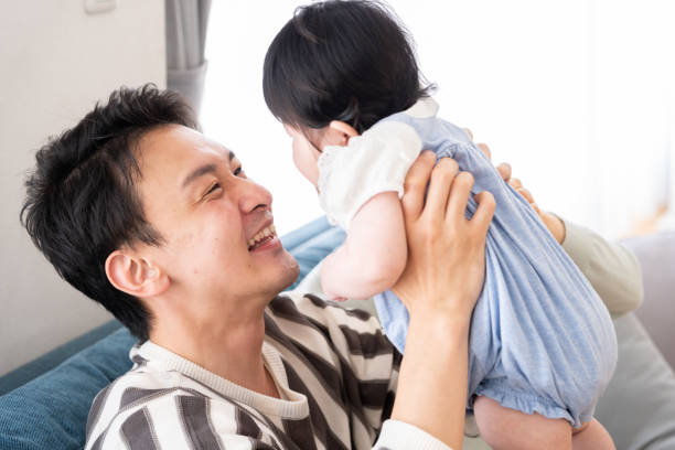 istock young asian family relaxing on sofa 996496286