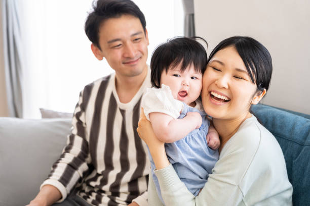 istock young asian family relaxing on sofa 996496304
