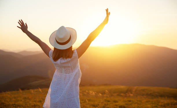 istock happy girl enjoying nature at sunset 996498634