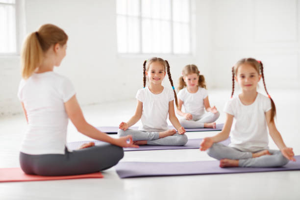 istock children practicing engaged in gymnastics and yoga with  teacher 996505042