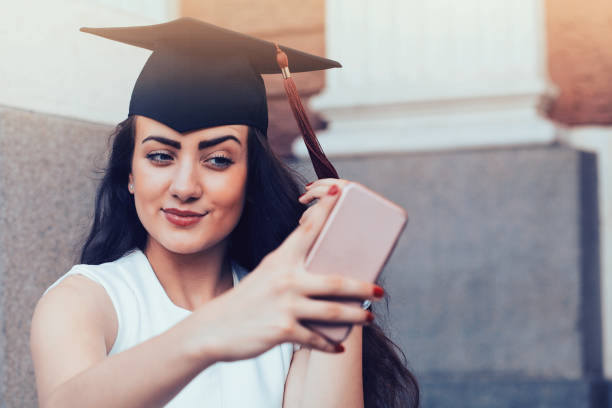 istock Happy graduate girl taking a selfie 996505250