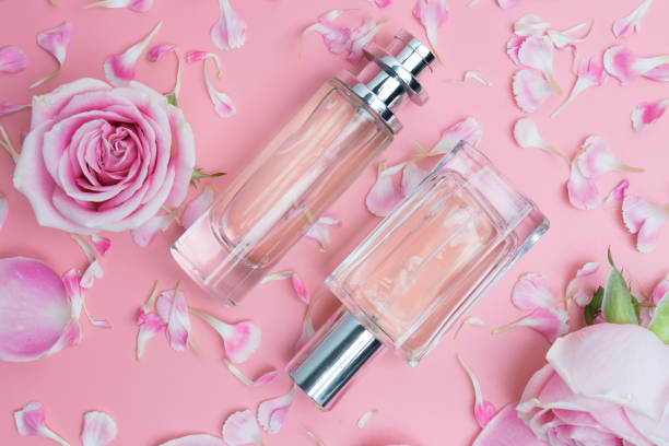 istock Beautiful perfume bottles on pink background 996520130