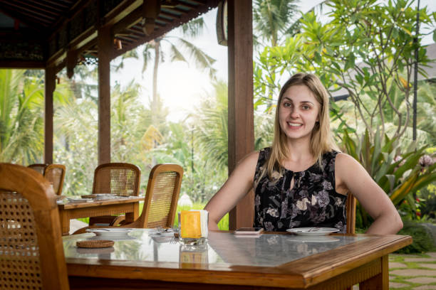 istock Happy young woman at the restaurant 996520236