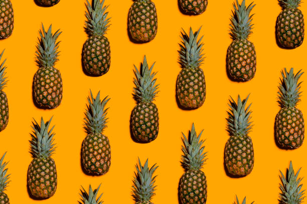 istock Pop Art Pineapple Fruit on a Orange Wallpaper Background 996555492