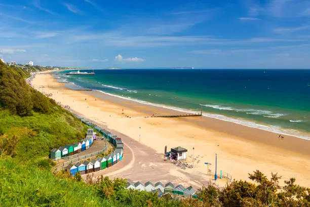 Sunshine illuminates golden beaches and blue-green seas along the Dorset coast at Middle Chine between Poole and Bournemouth