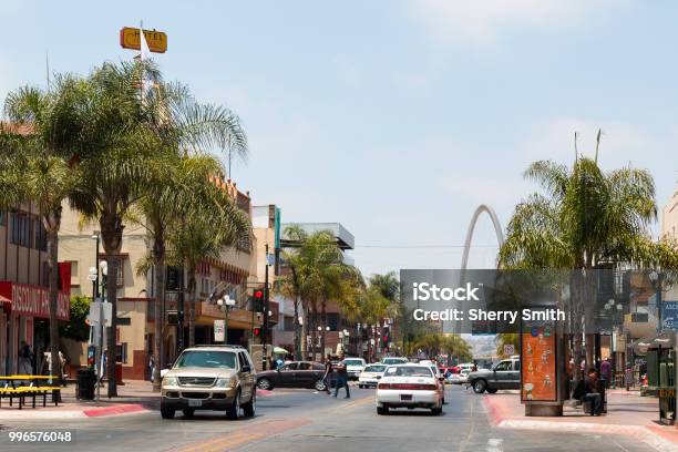 Traffic Along Avenida Revolucion With Monumental Arch In Tijuana Mexico Stock Photo - Download Image Now