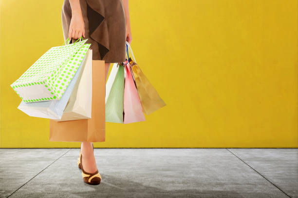 istock Woman with shopping bag standing 996582520