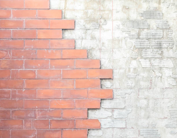 istock Closeup old and damaged red stone brick wall texture background 996583132