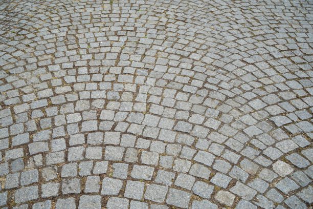istock Ground pattern of grey brick granite stone texture outdoor pedestrian pavement surface in rough square cut pattern background under sunlight, historical site 996612144