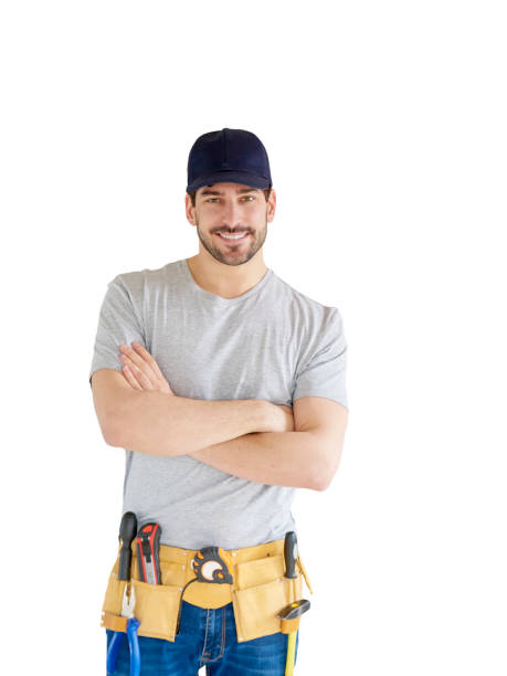 Smiling young handyman portrait Portrait of happy young handyman standing with arms crossed at isolated white background with copy space. Successful repairman wearing baseball cap and tool belt. tool belt stock pictures, royalty-free photos & images