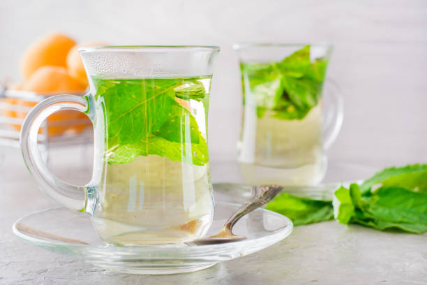istock Hot tea with mint leaves in transparent glasses 996620812
