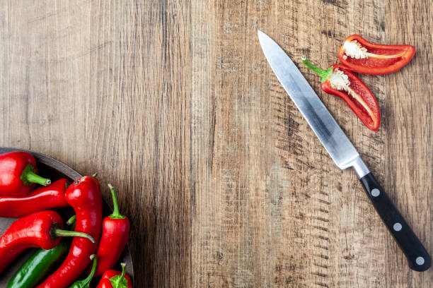 istock Red and green chilli pepper in a dish on wooden table with copy space 996622092