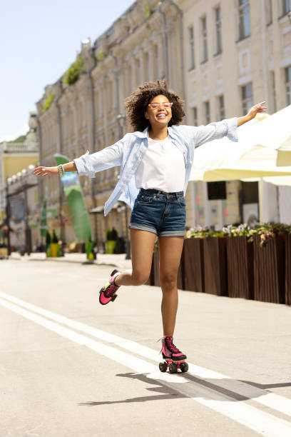istock Cheerful curly girl enjoying roller-skating 996626792