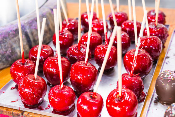 istock Red apples on a stick in caramel yum yum 996635878